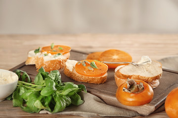 Woman preparing delicious bruschettas on table