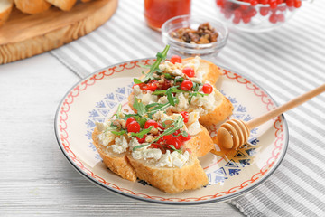 Woman preparing delicious bruschettas on table
