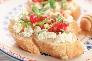 Woman preparing delicious bruschettas on table