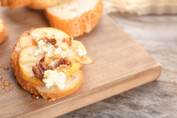 Woman preparing delicious bruschettas on table