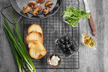 Woman preparing delicious bruschettas on table