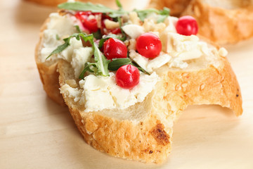 Woman preparing delicious bruschettas on table