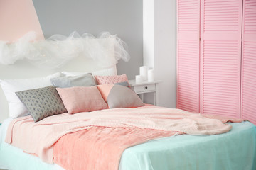 Comfortable bed with pillows in room