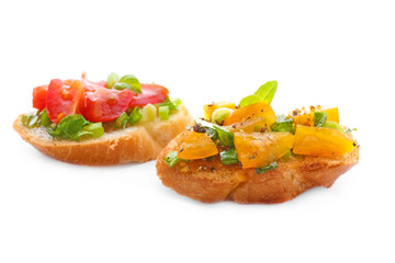 Tasty bruschettas with tomatoes on white background