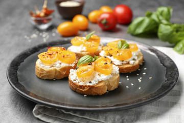 Tasty bruschettas with tomatoes on plate