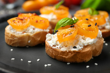 Tasty bruschetta with tomatoes on plate, closeup