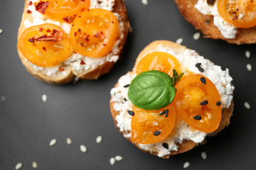 Tasty bruschettas with tomatoes on plate, closeup