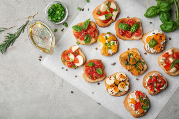 Tasty bruschettas with tomatoes on table, top view