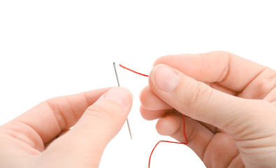Woman threading needle on white background, closeup