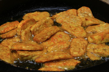 Famous Javanese cuisine food : Tempe or Tempeh made of  fermentation process that binds soybeans into a cake form, sliced and fried. Famous in Indonesia and Malaysia