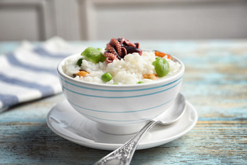 Dish with tasty seafood risotto on table