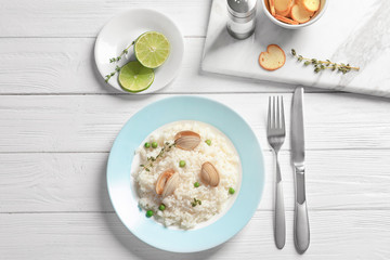 Plate with tasty seafood risotto on table