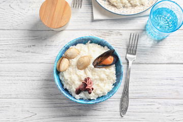 Dish with tasty seafood risotto on table