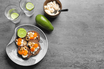 Tasty bruschettas with cherry tomatoes and olives on plate