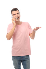 Attractive young man talking on mobile phone on white background