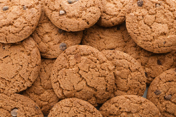 Delicious oatmeal cookies with chocolate chips as background