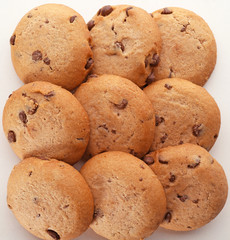 Delicious oatmeal cookies with chocolate chips on white background