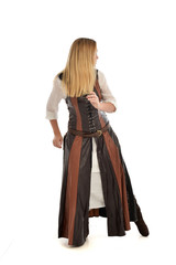 full length portrait of girl wearing brown  fantasy costume, standing pose with back to the camera on white studio background. 