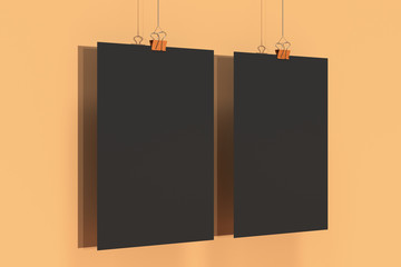 Two blank black posters with binder clip mockup on orange background