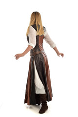 full length portrait of girl wearing brown  fantasy costume, standing pose with back to the camera...
