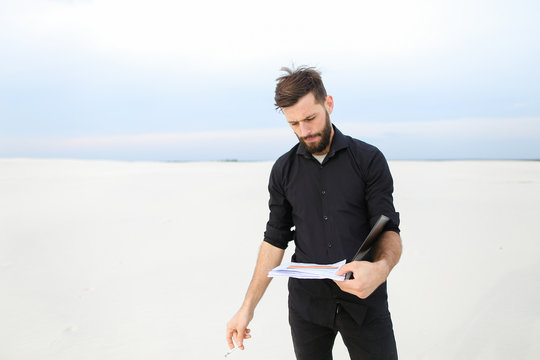   Geographer Male Smoking Carrying Out Research On Seaside. 