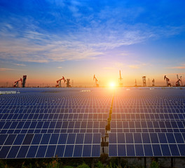 Clean power energy concept,Oil pump with solar panels and the sunset