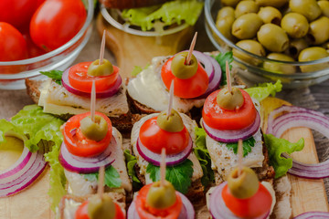 canapé with herring,sandwiches with herring,sandwiches for a buffet table.