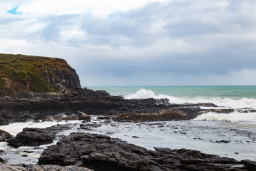 Fototapeta na wymiar New Zealand Curio Bay cliffs and waves
