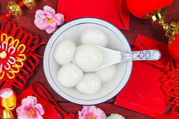 Chinese Lantern Festival food,ang pow or red packet and gold ingots. Chinese characters means...