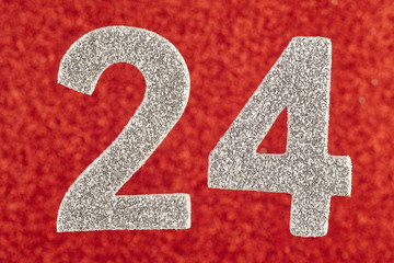 Number twenty-four silver color over a red background. Anniversary