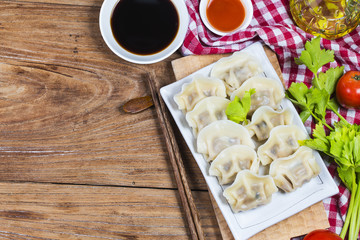 Asian dumplings in bowl, chopsticks, Chinese dumplings for dinner.Chinese dumplings for dinner/lunch. Traditional Asian/Chinese cuisine.