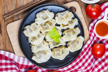 Asian dumplings in bowl, chopsticks, Chinese dumplings for dinner.Chinese dumplings for dinner/lunch. Traditional Asian/Chinese cuisine.