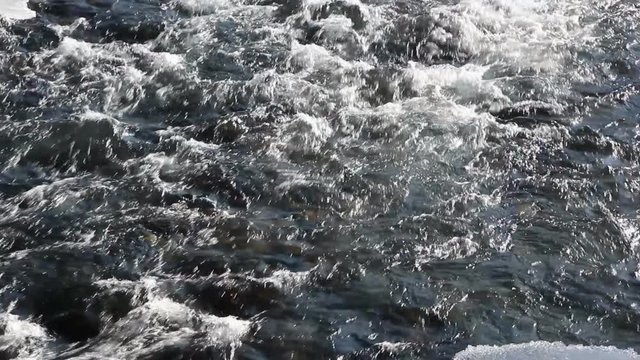 Stormy stream of water in the river in the spring in back lit , Chemal River, Altai, Russia
