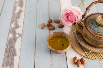 Fototapeta na wymiar tea set and almon nut on old wood background