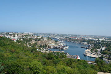 The view of the city of Sevastopol Nakhimovskiy district, the Black sea and the port from the Ferris wheel on a Sunny day. Republic Of Crimea, Russia.