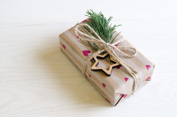 Christmas still life with gifts on a black wooden background with a Christmas tree. New Year gifts