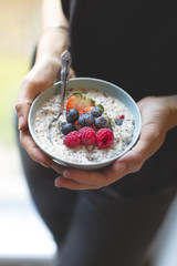 Bowl with cereals porridge in hands