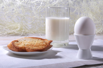 Morning Breakfast set with egg, orange jam on bread toast and milk in glass.