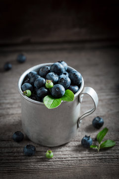 Tasty blueberry in the old metal mug