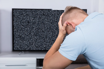 Man In Front Of Television With No Signal