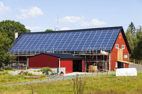 Barn with solar panels and ongoing construction work