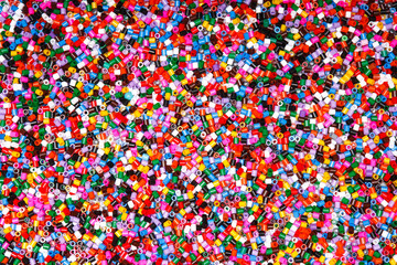 Background of multicolored decorative plastic craft beads.  