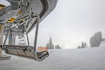 Ski lift on ski slopes on mountain resort