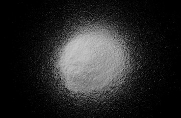 Pile of coconut flour, powder isolated on black background, top view