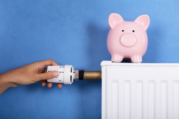 Person Hand Adjusting Temperature On Thermostat