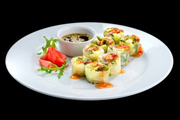 Fresh Vegetable Spring Rolls with soy sauce and ginger in a white plate, isolated on black background