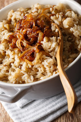 Vegetarian Mujaddara from rice and lentils with caramelized onion macro. vertical