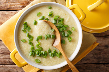 egg drop soup with fresh green onion macro in a bowl. Horizontal top view