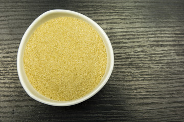 Bowl with cane sugar. View from above.