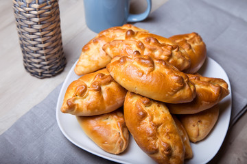 Traditional Russian baked pies (pirozhki). Close-up, selective focus.